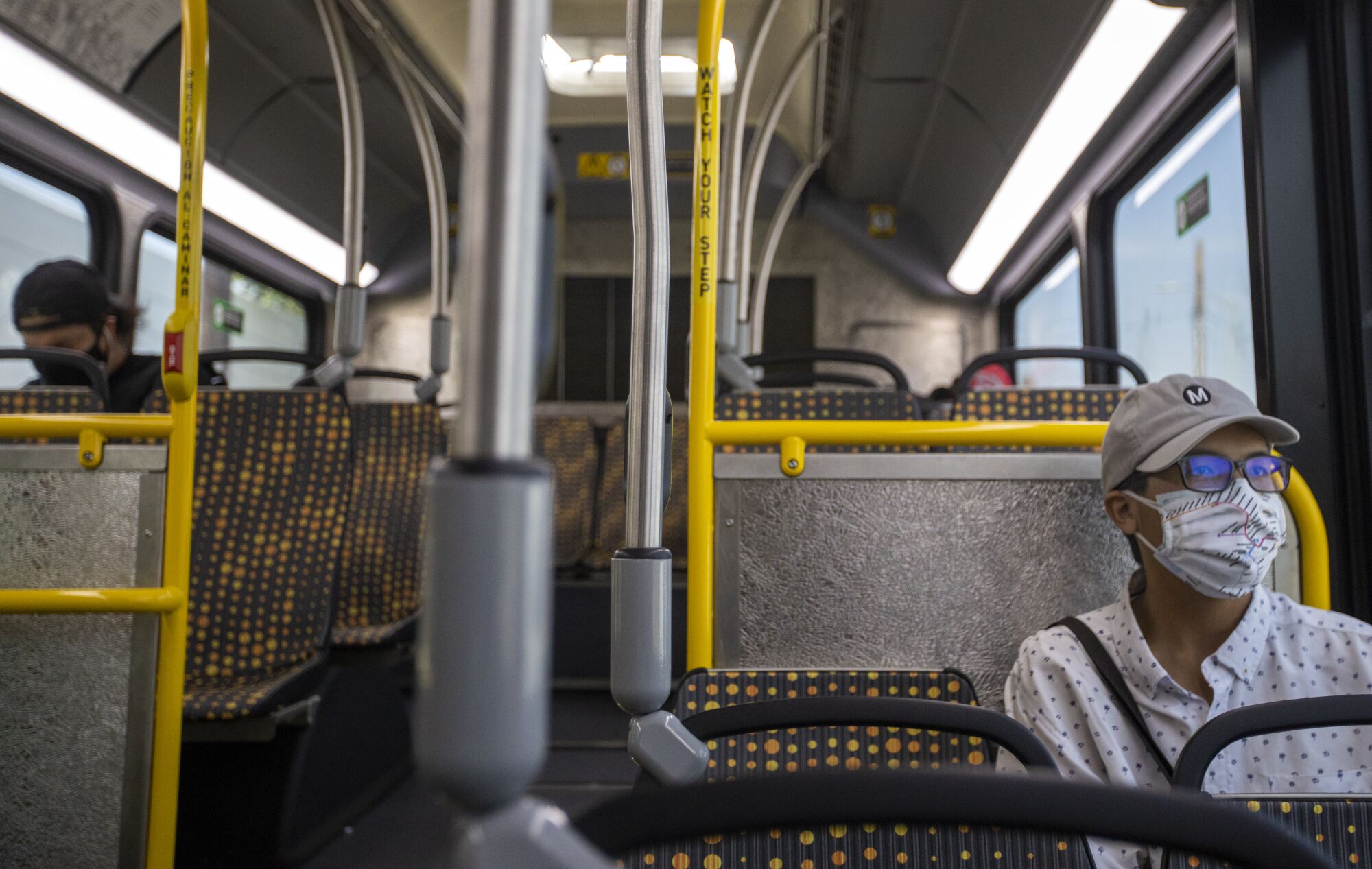Kenny Uong wears a transit face mask on the Metro Line 4 along Santa Monica and Sunset boulevards in Los Angeles.