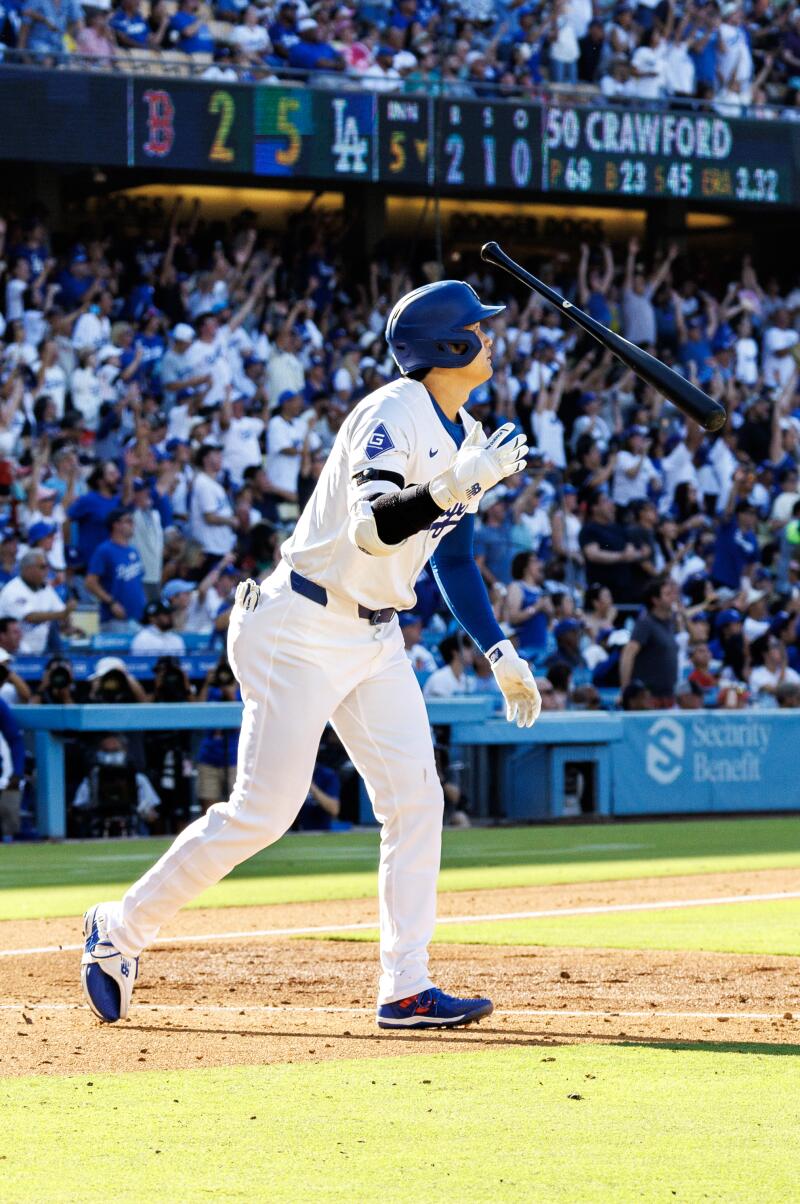 Dodgers star Shohei Ohtani tosses his bat after hitting a 473-foot home run at Dodger Stadium.