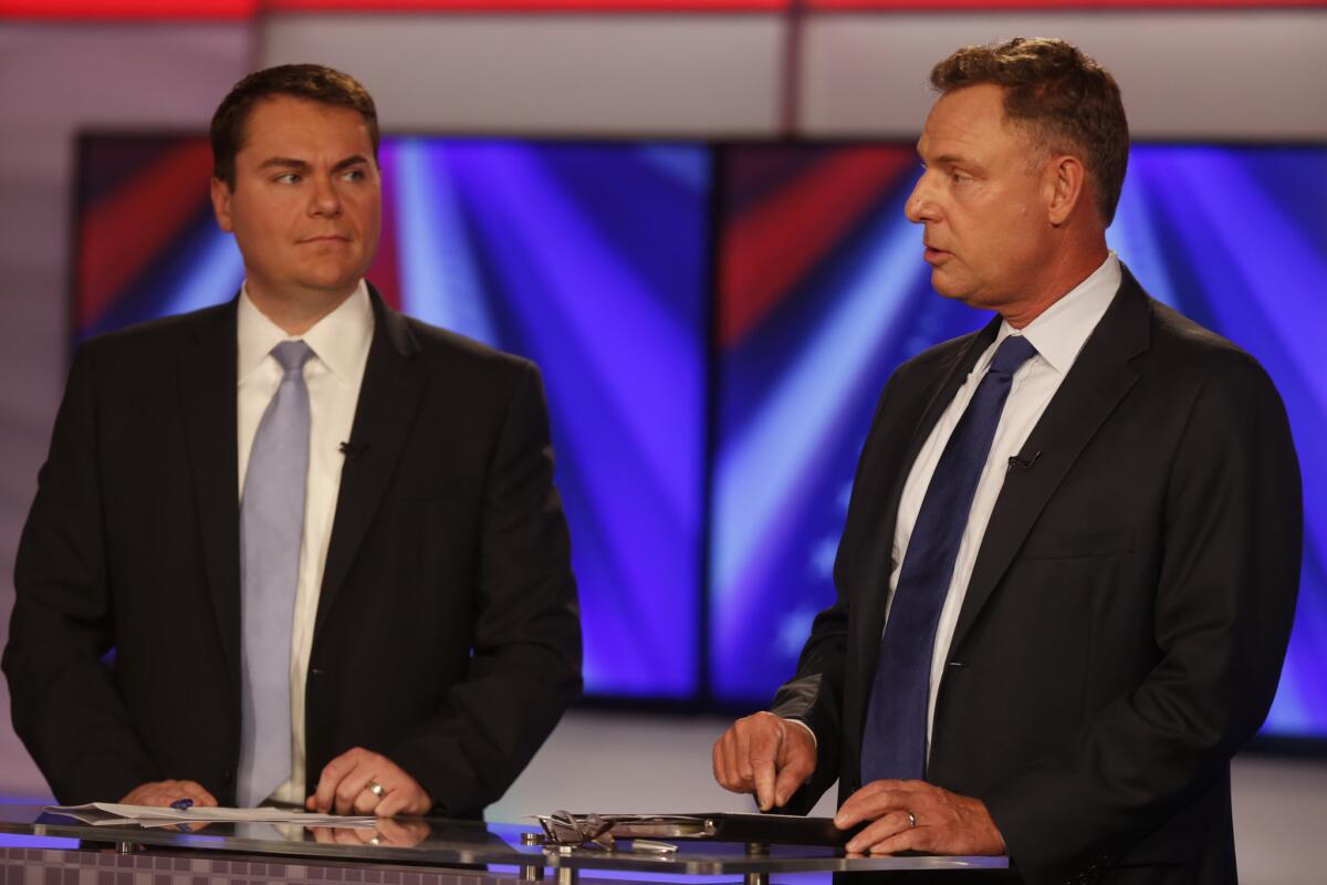 Rep. Scott Peters (D-San Diego), right, faced a tough reelection challenge last year from Republican Carl DeMaio, left, during a 2014 debate with Peters.