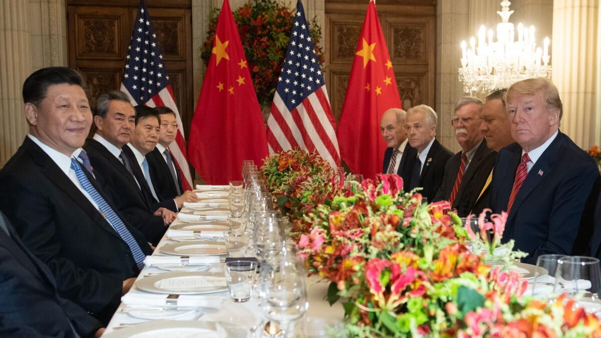 US President Donald Trump, right, and members of his delegation have dinner with China's President Xi Jinping, left, and Chinese government representatives, at the end of the G20 Leaders' Summit in Buenos Aires.