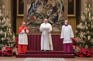 Pope Francis delivers a Christmas Day speech from inside a cavernous hall at the Apostolic Palace.