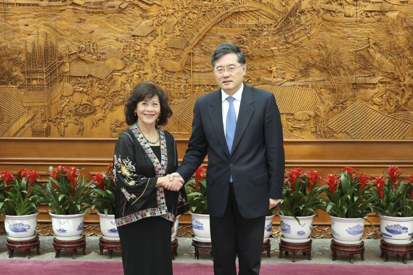 In this photo released by Xinhua News Agency, Chinese Foreign Minister Qin Gang at right meets with Noeleen Heyzer, special envoy of the secretary-general of the United Nations (UN) for Myanmar, in Beijing on Monday, May 1, 2023. Qin called for stability and a crackdown on cross-border criminal activity along the country's border with Myanmar, during an unusual visit to the volatile region on Tuesday. (Pang Xinglei/Xinhua via AP)