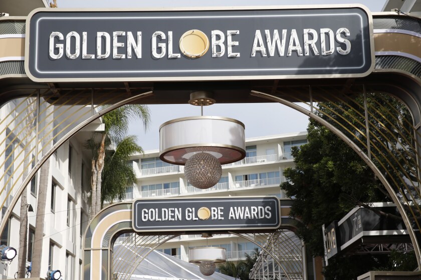 A sign on an archway in front of a hanging glitter ball reads "Golden Globe Awards"