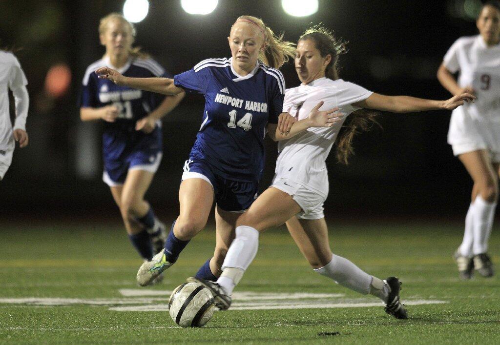 Newport Harbor High's Jessica Prather (14) battles to control the ball against Estancia's Alba Barrios during the second half in a nonleague game at Jim Scott Stadium on Thursday.