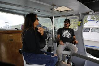 Cynthia and Lance Keener, owners of Ohana Fishing Charters, sit on their boat in Lihue, Hawaii, Thursday, March 4, 2021. The rural island in Hawaii is one of the world's most sought-after vacation destinations, but it has been nearly impossible to visit for most of the past year because of quarantine and other coronavirus restrictions. Keener said he lost nearly all of his business when the county shut down last March. Things haven't gotten any better, and he looks forward to when the state lifts restrictions in April. (AP Photo/Caleb Jones)