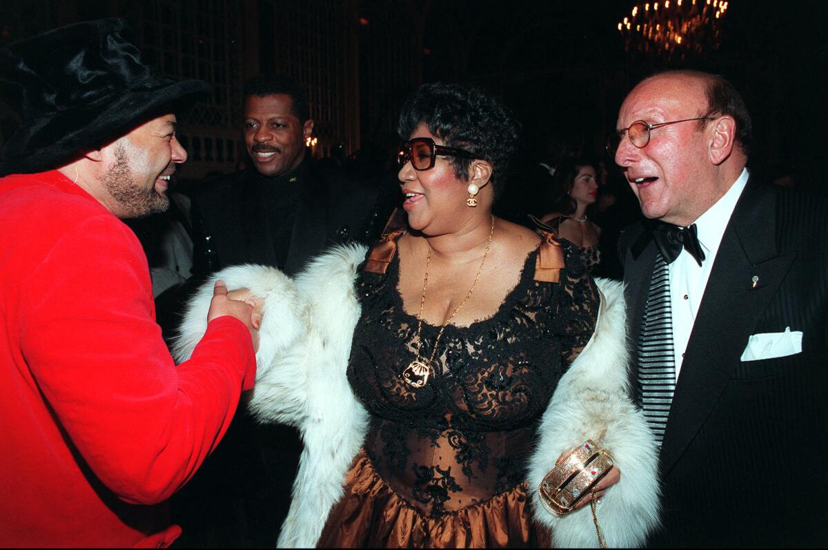 Narada Michael Walden, left, greets Aretha Franklin and Clive Davis at a Grammy eve cocktail party in New York in 1997.