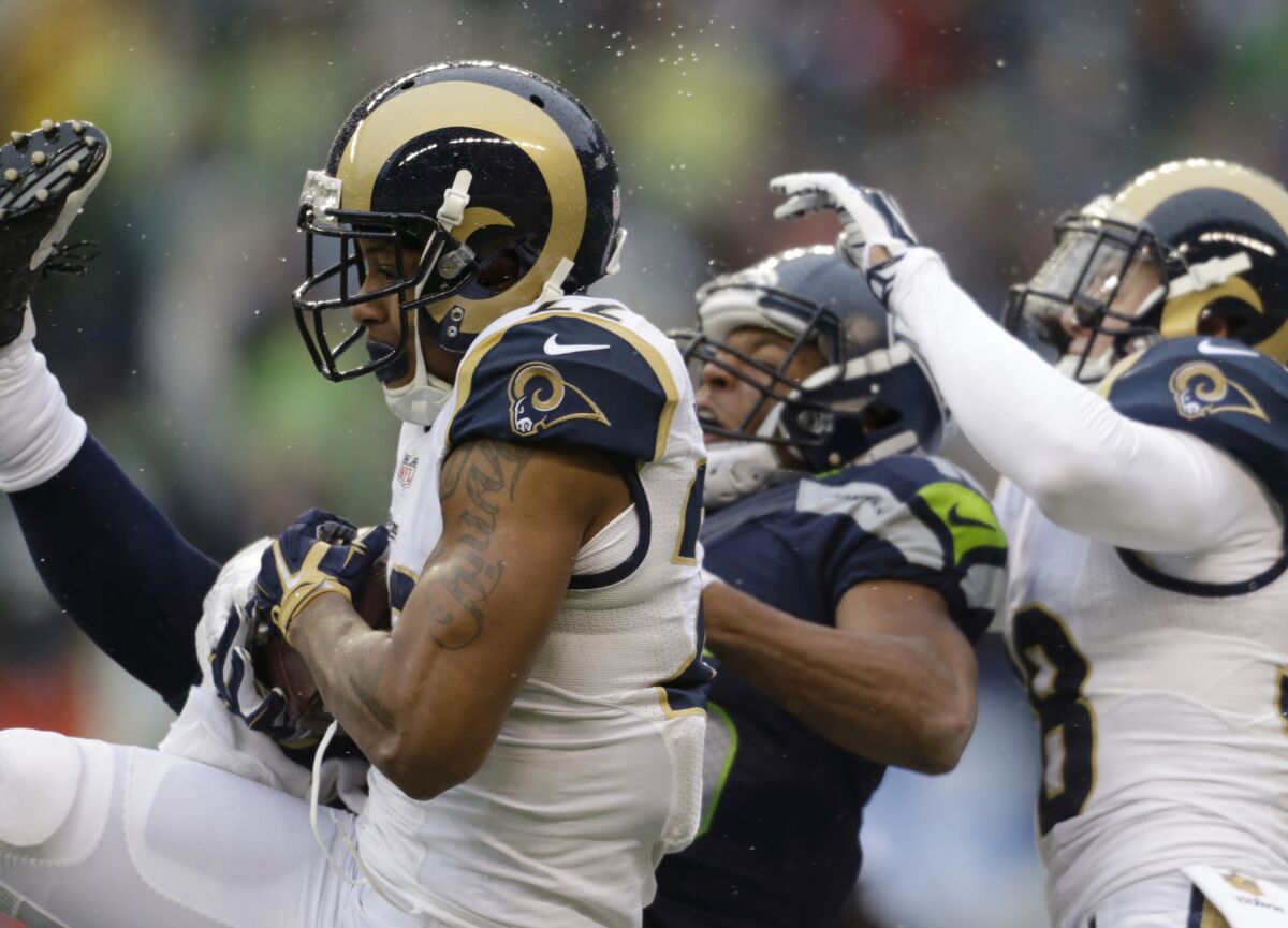 Cornerback Trumaine Johnson, left, intercepts a pass intended for Seahawks receiver Tyler Lockett, center, during the first half of a game on Dec. 27.