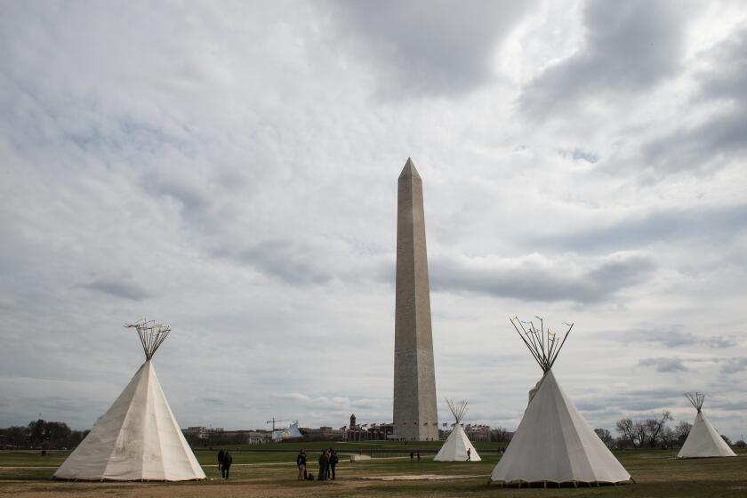 Tepees stand near the Washington Monument at the start of a four-day protest against the Dakota Access pipeline and President Trump.