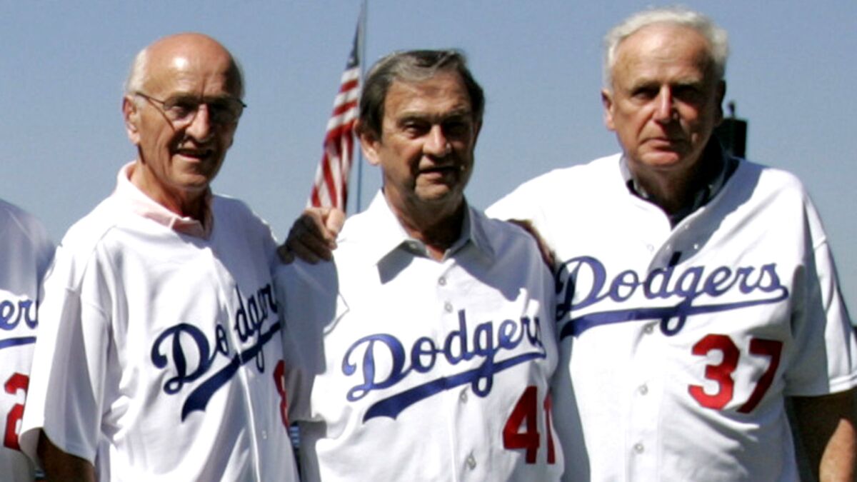 Ed Roebuck. right, poses with other members of the Dodgers' 1955 championship team including George Shuba, left, and Clem Labine at a Dodgers Stadium reunion in 2005.
