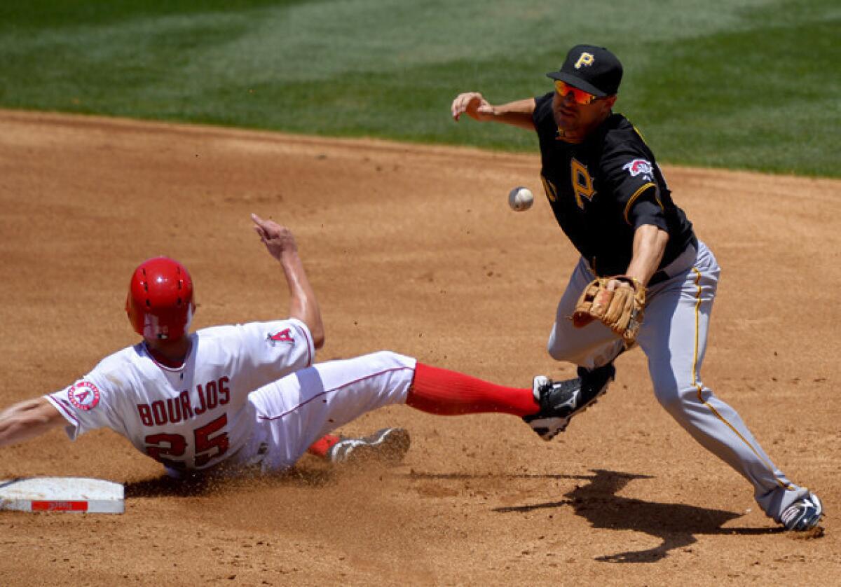 Angels' Peter Bourjos, left, is forced out at second, but breaks up Pittsburgh Pirates shortstop Jordy Mercer's double play attempt on a fielder's choice by Mike Trout and during the second inning.