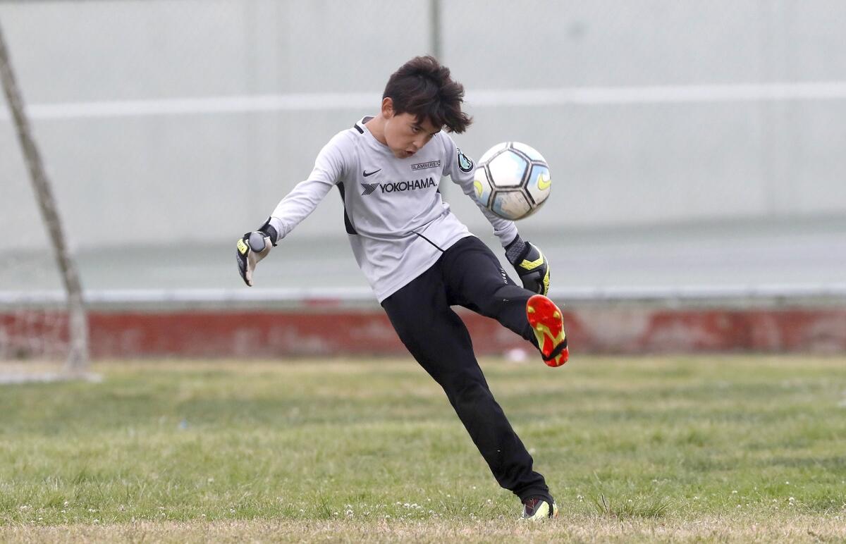 Carden Hall goalkeeper Emilio Lopez kicks the ball against Newport in a boys’ fifth- and sixth-grade Bronze Division pool-play match at the Daily Pilot Cup on Friday at Costa Mesa High.