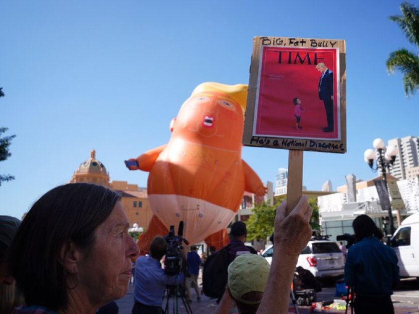 Protesters inflate a “baby Trump” balloon in downtown San Diego