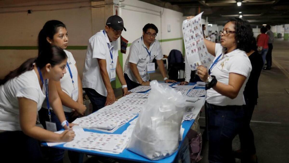 Los funcionarios de la junta electoral cuentan los votos después del cierre de las urnas, en la ciudad de Guatemala, el domingo.