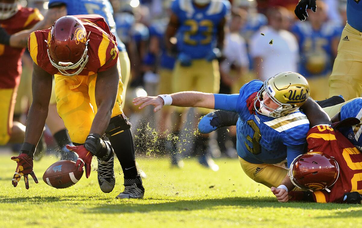 USC defensive lineman Rasheem Green collects the ball after UCLA quarterback Josh Rosen was sacked by Claude Pelon and fumbled in the second half. Green ran 31 yards for a score.