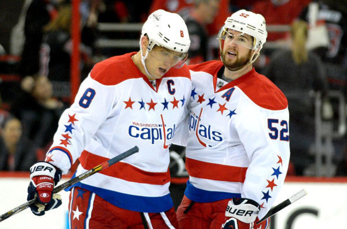 Capitals right wing Alexander Ovechkin is congratulated by teammate Mike Green scoring his 400th career goal in the third period against the Carolina Hurricanes.