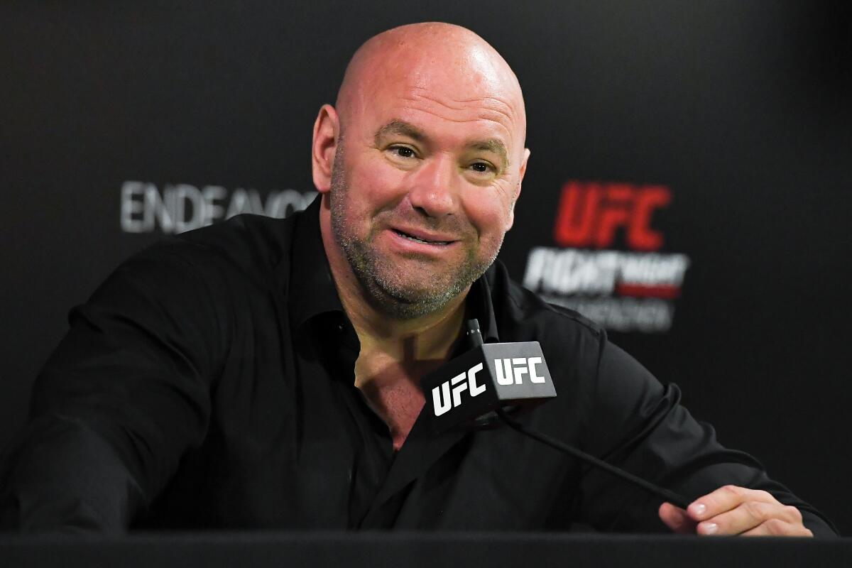 UFC President Dana White at a microphone with a UFC symbol