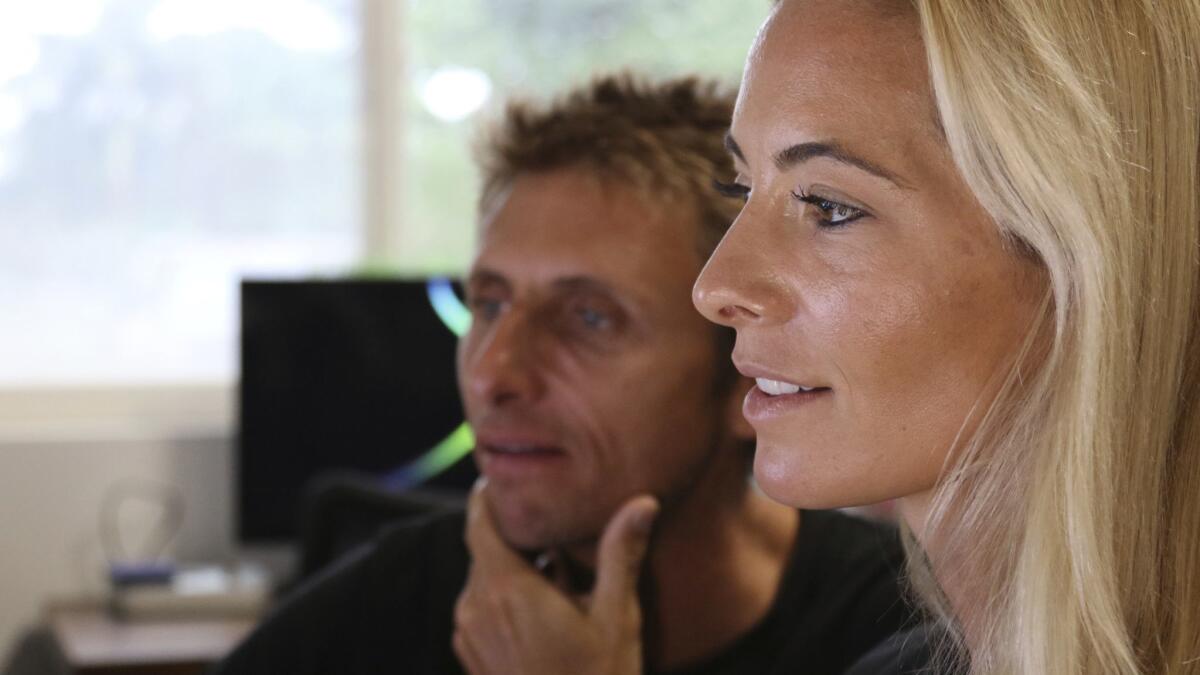 Juan Oliphant, left, and Ocean Ramsey, co-founders of One Ocean Diving and Research, look at footage of their encounter with a great white shark.