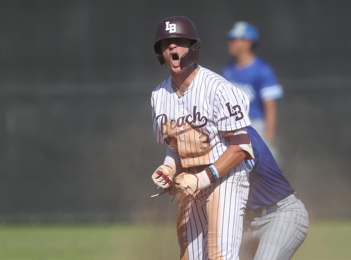 Laguna Beach's Otis Boultinghouse (3) gets fired up for his team after hitting a double against Norco on Tuesday.