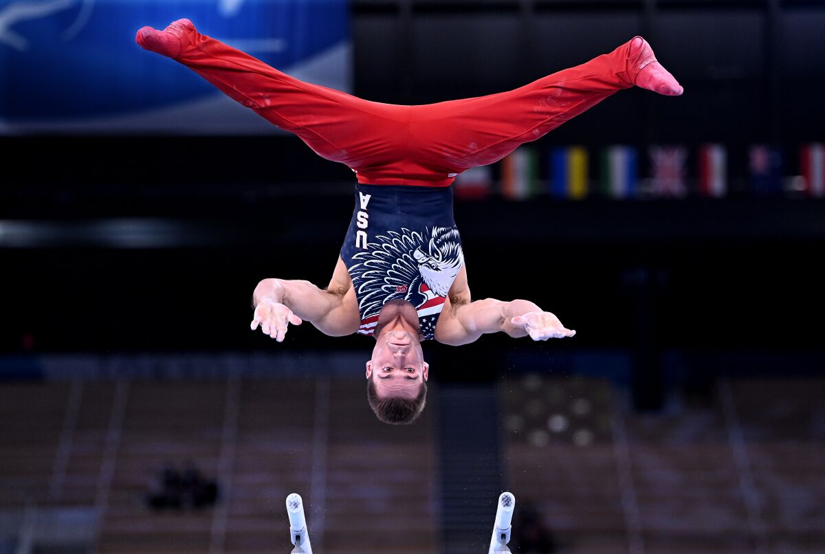 Sam Mikulak of the U.S. soars upside down and over the parallel bars.