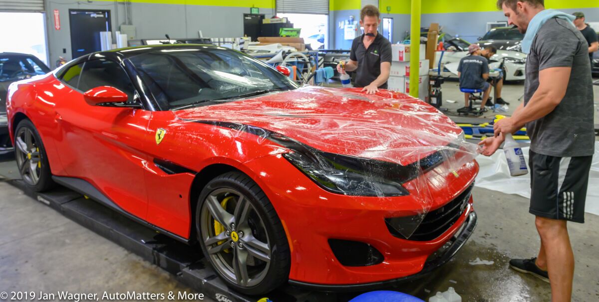 Ferrari getting wrapped with XPEL ULTIMATE PLUS paint protection film at AUTO ARMOUR