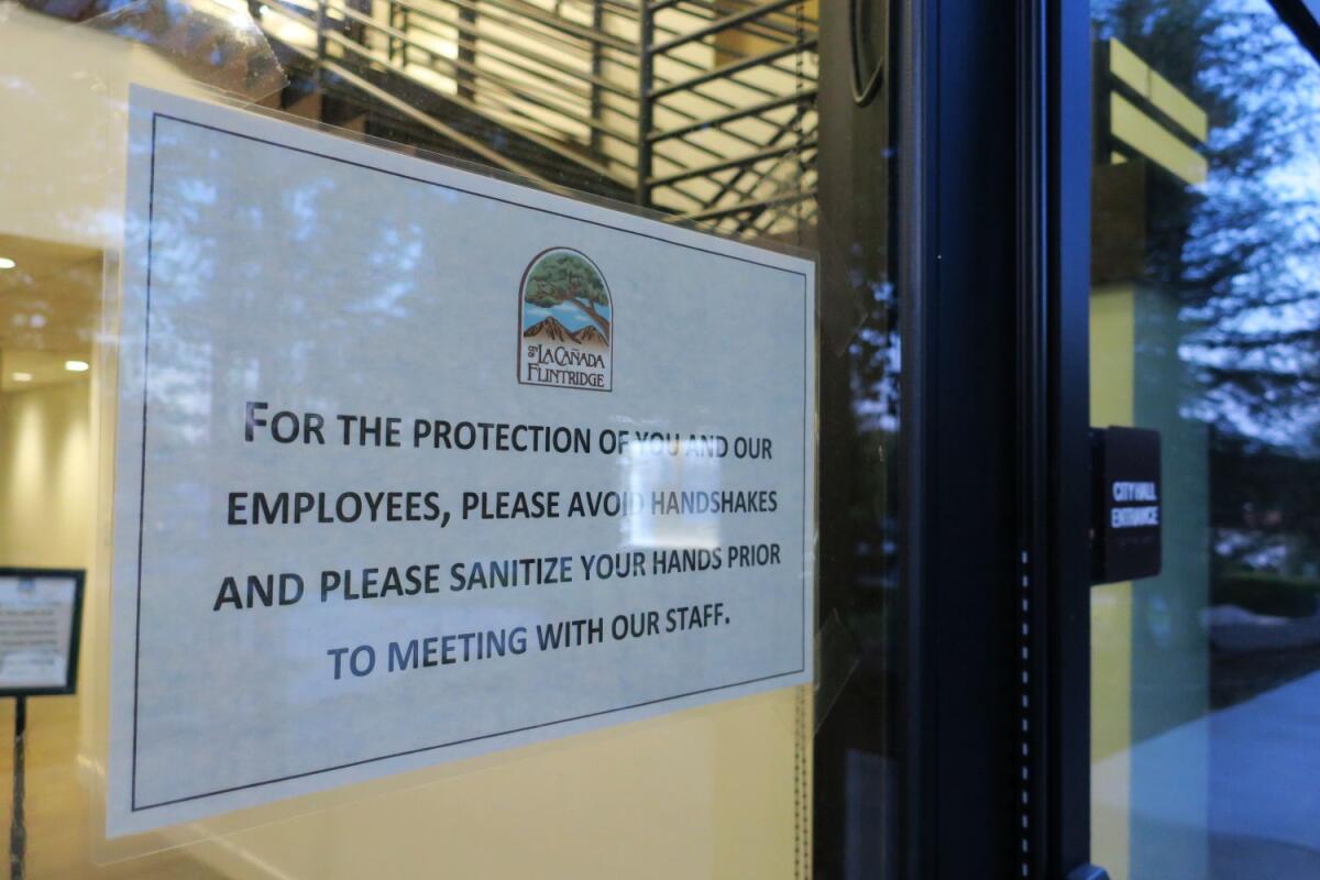 A sign outside La Cañada's City Hall Tuesday encouraged visitors to practice good hygiene to combat the spread of the novel coronavirus. Starting Thursday, City Hall will close to walk-in visitors.