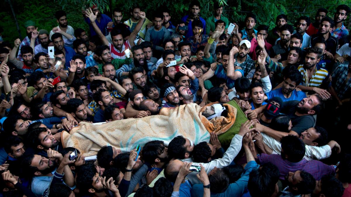 Supporters carry the body of militant leader Burhan Wani during a funeral procession in Tral, in Indian-administered Kashmir, on July 9.