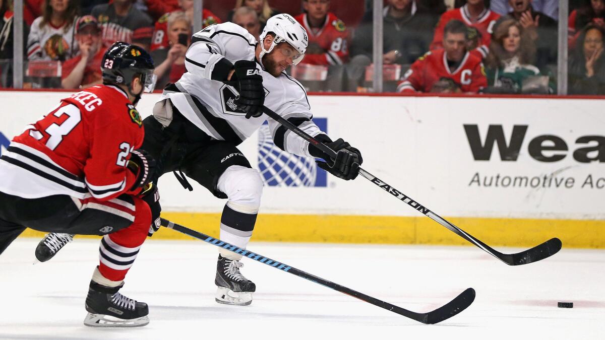 Kings forward Marian Gaborik, right, shoots the puck in front of Chicago Blackhawks forward Kris Versteeg during the Kings' 4-1 loss Monday.