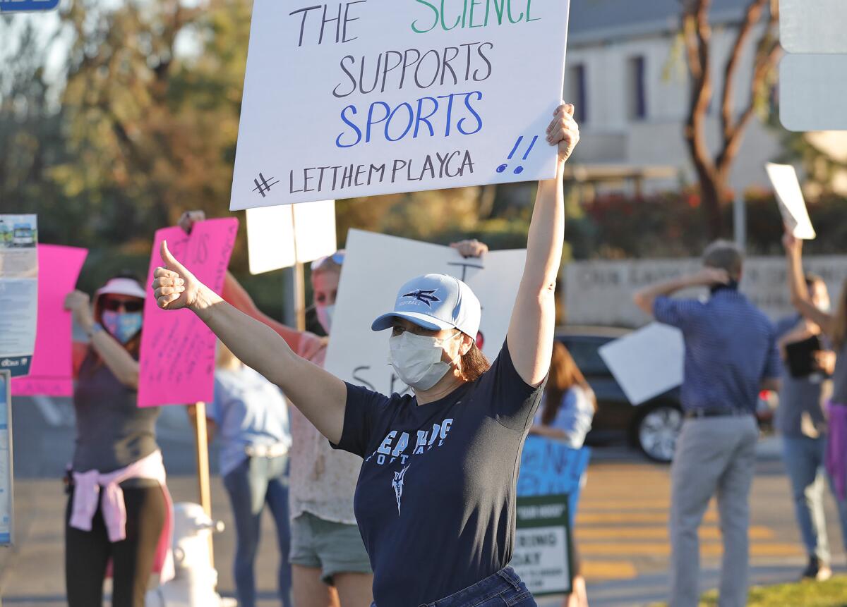 Parents and student-athletes participate in the statewide "Let Them Play" rally at Corona del Mar High on Friday.