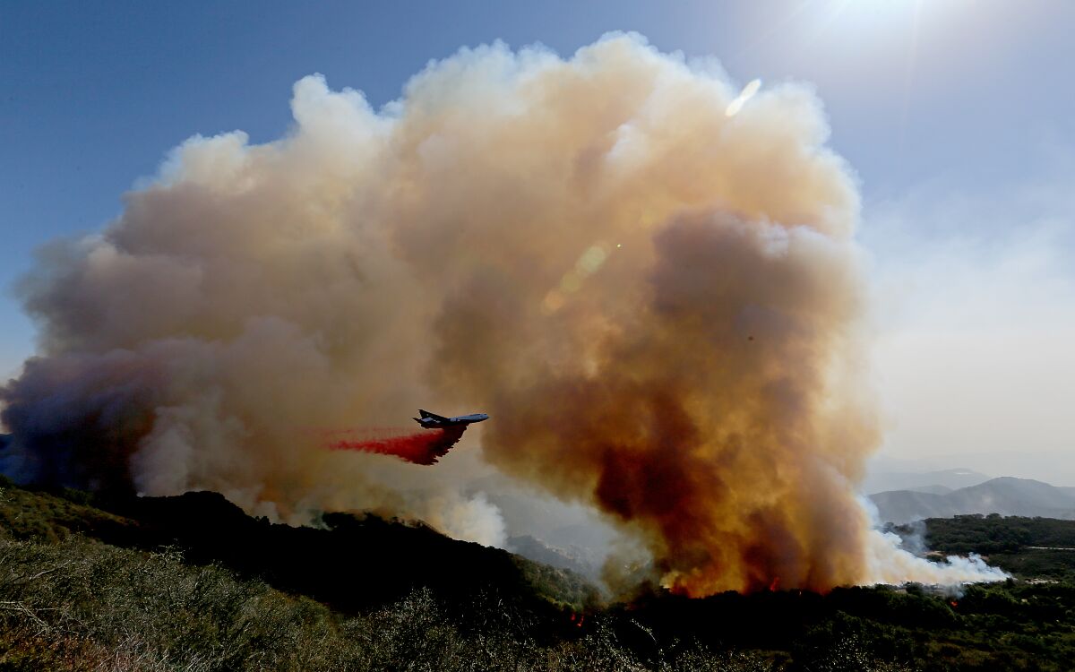 A firefighing airplane drops fire retardant ahead of the Alisal fire near Goleta on Wednesday.