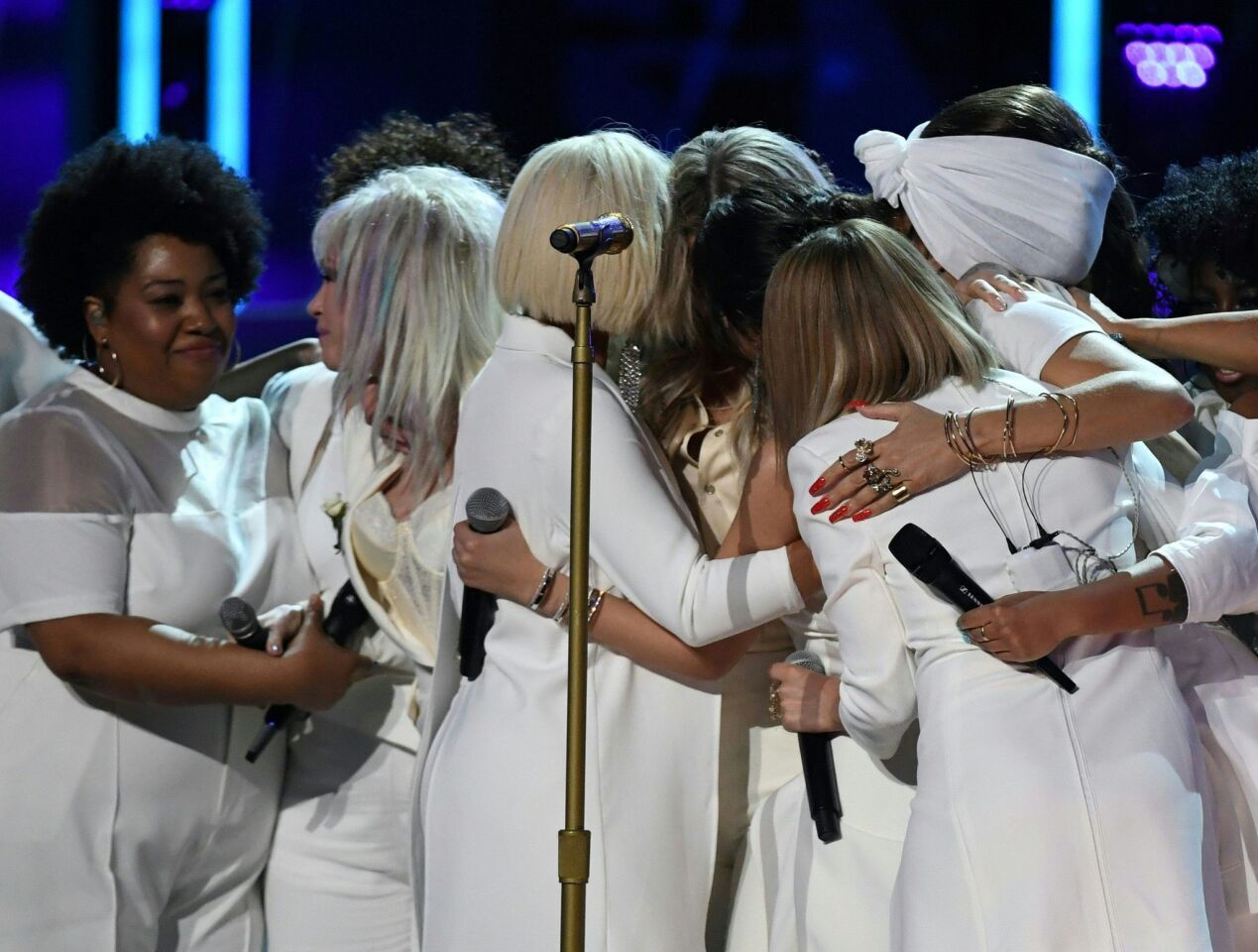 Kesha is hugged by Bebe Rexha, Cindy Lauper, Camila Cabello and Andra Day.