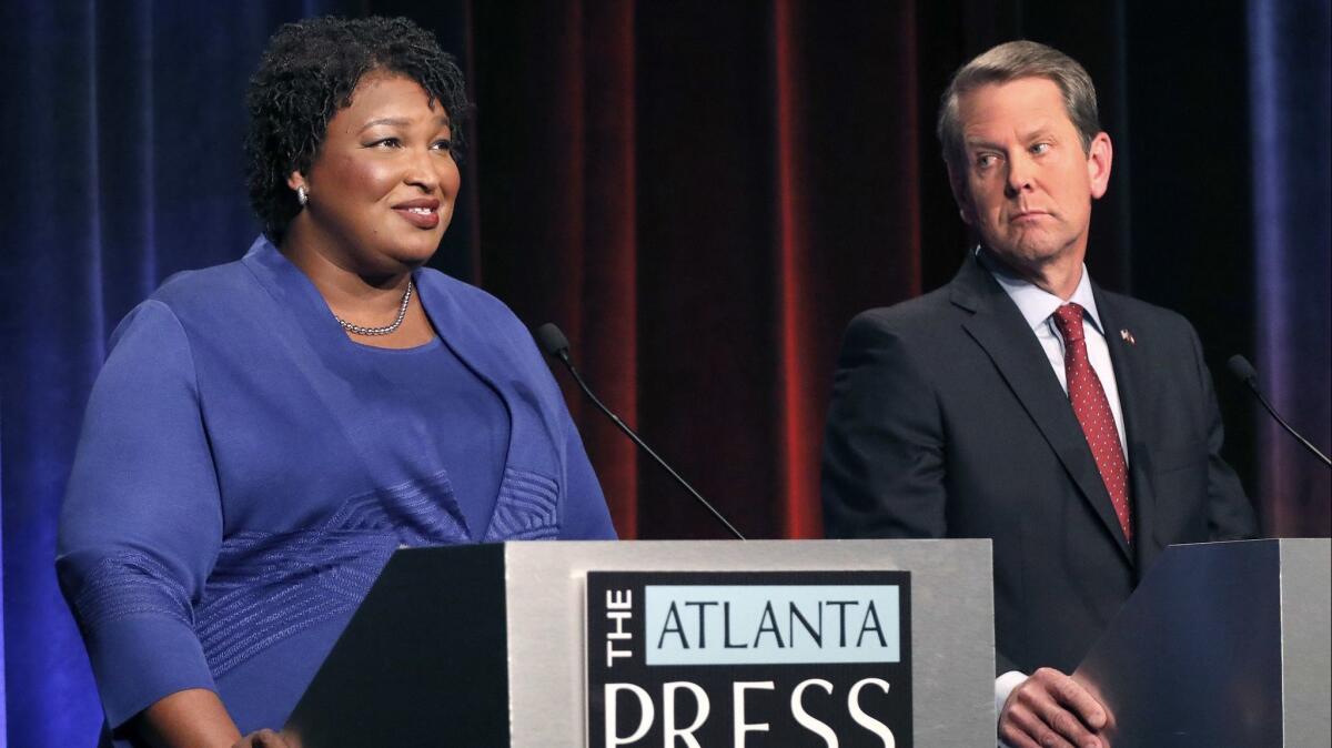 Stacey Abrams and Georgia Secretary of State Brian Kemp debate on Oct. 23. They are running neck-and-neck in recent polls.