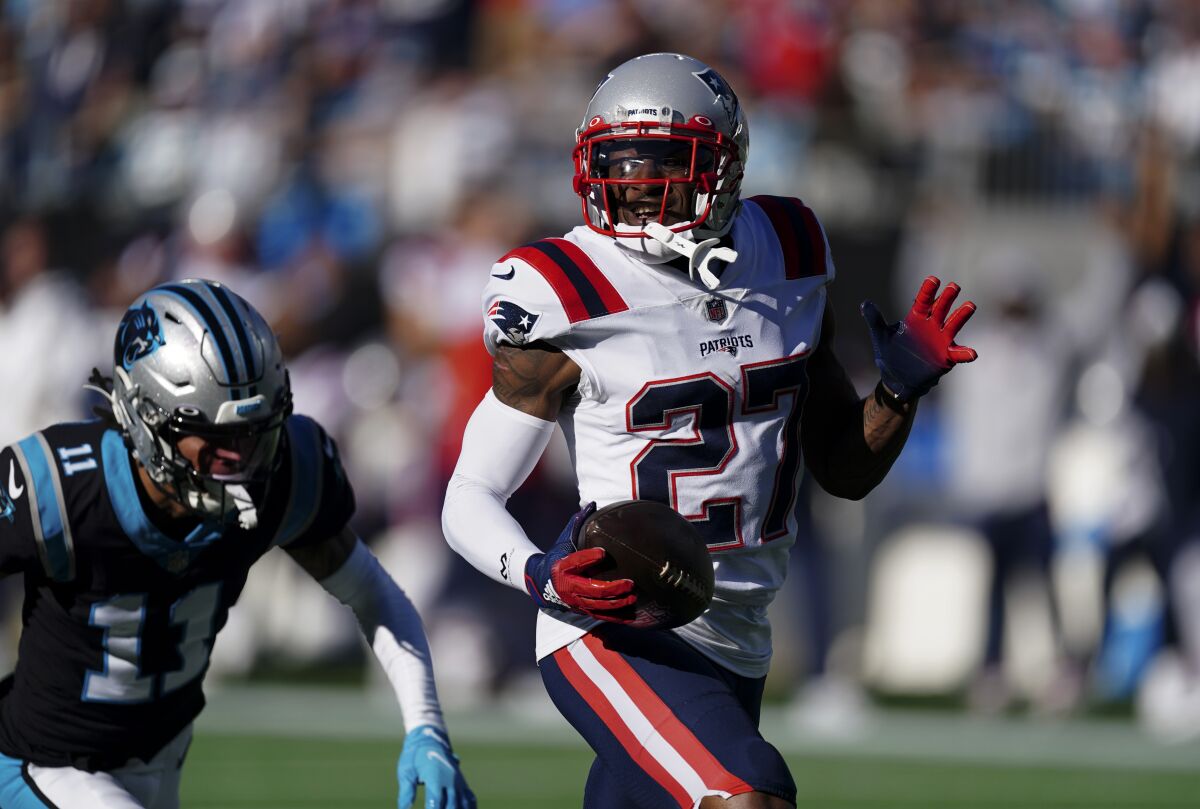 New England Patriots cornerback J.C. Jackson runs for a touchdown after an interception.