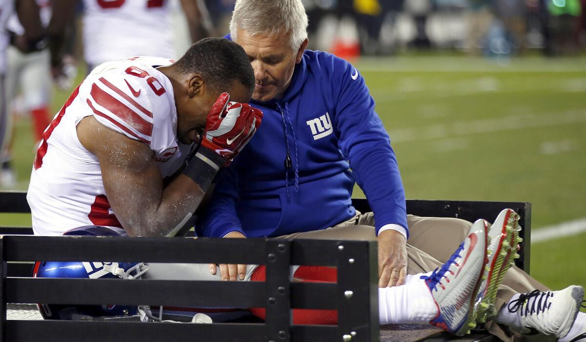 Giants wide receiver Victor Cruz is carted off the field after tearing the patellar tendon in his right knee during the second half of a game against the Eagles on Sunday night in Philadelphia.