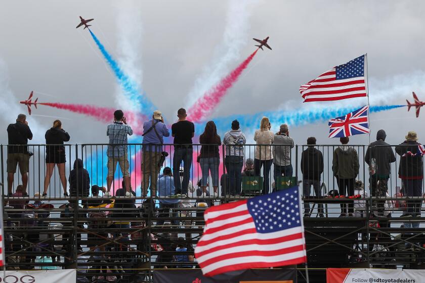 People watch the Royal Air Force Red Arrows perform during the MCAS Miramar Airshow at Marine Corps Air Station Miramar on Saturday, September 28, 2019 in San Diego, California.