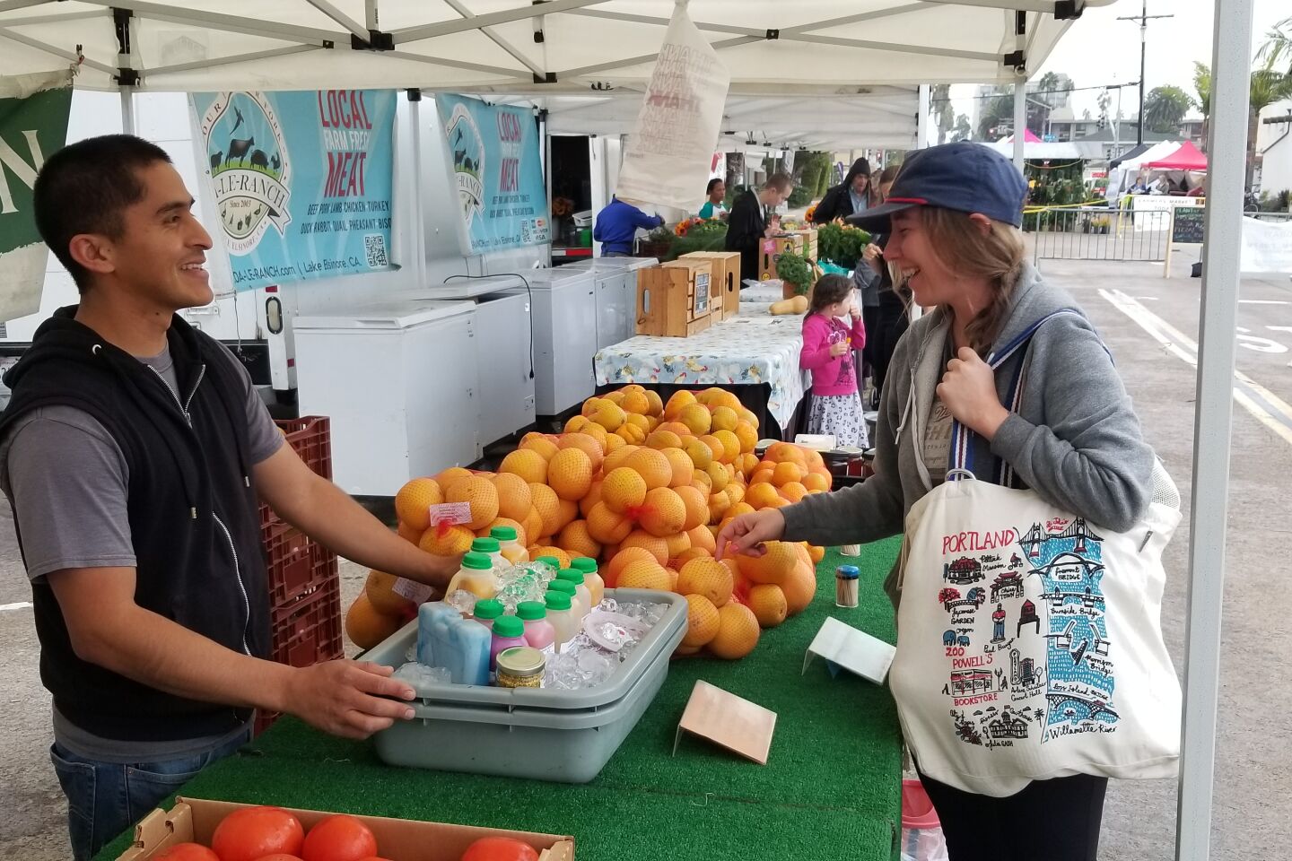 Carmelo Martinez of Heritage Family Farms sells grapefruit to Nina LiGreci.