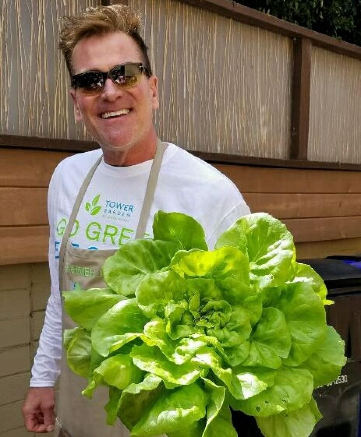 Joe Wesley grows butter lettuce in vertical towers on the roof of his home in University Heights.