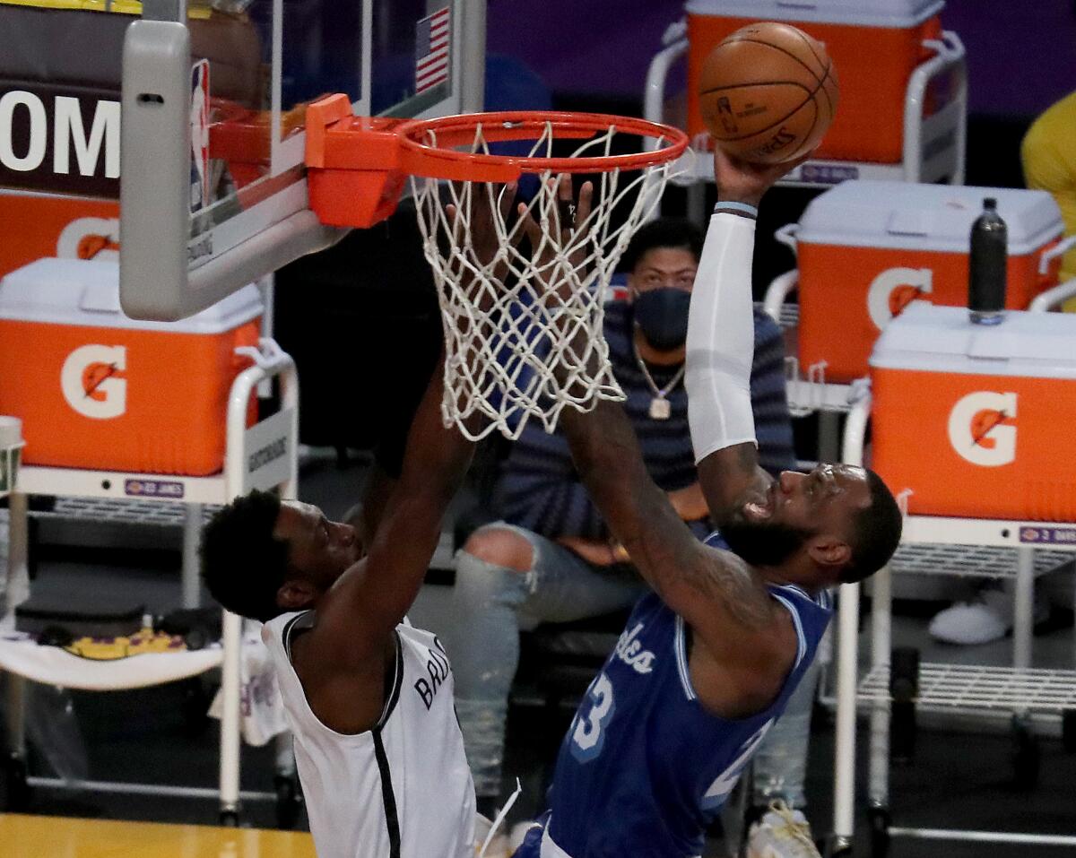 Lakers forward LeBron James shoots and scores against Brooklyn Nets forward Jeff Green.