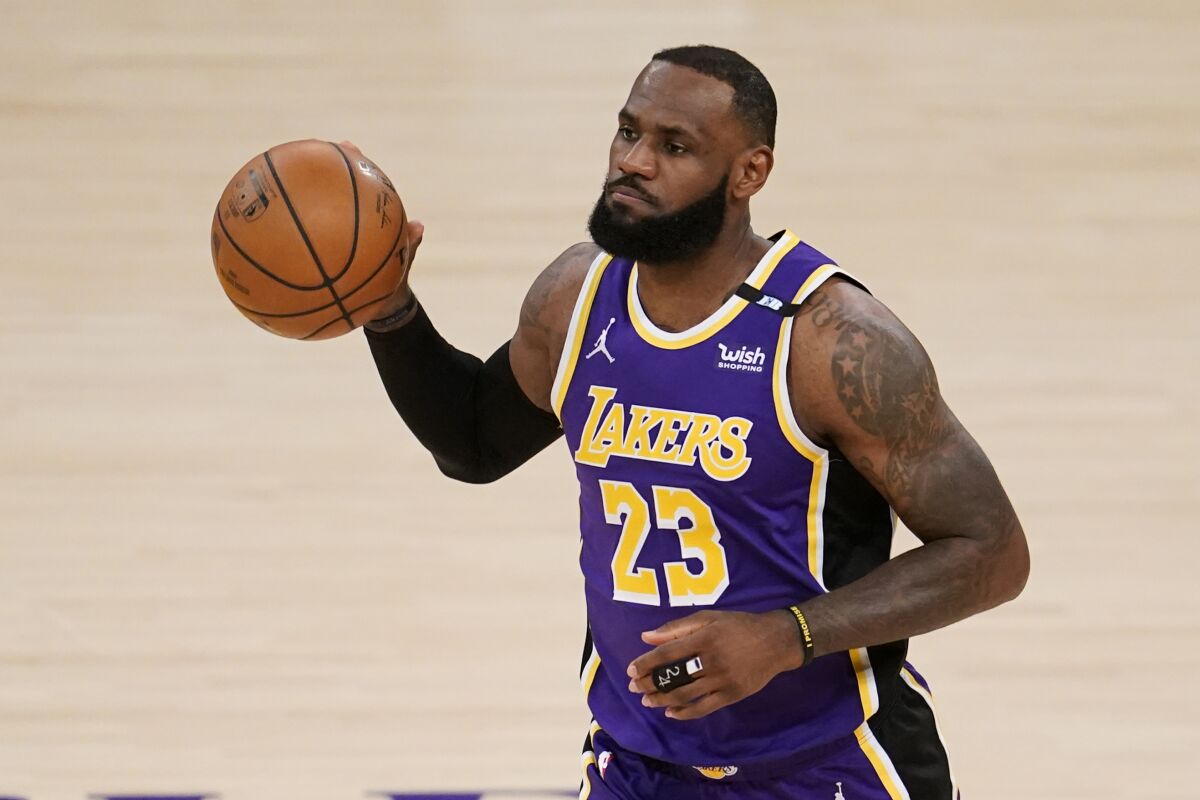 Los Angeles Lakers' LeBron James dribble the ball during the first half of the team's NBA basketball game against the Sacramento Kings on Friday, April 30, 2021, in Los Angeles. (AP Photo/Marcio Jose Sanchez)
