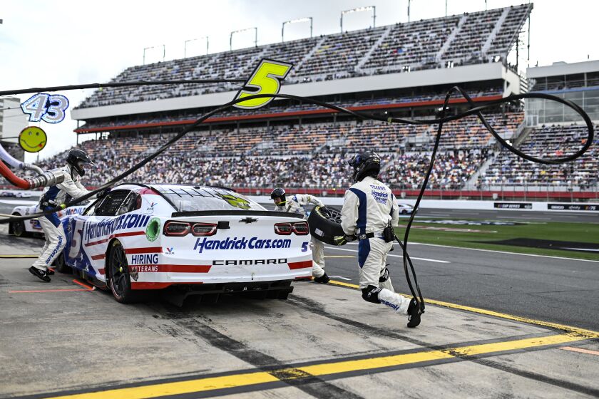 The pit crew for Kyle Larsonr rushes to complete a pit stop during a NASCAR Cup Series auto race at Charlotte Motor Speedway, Monday, May 29, 2023, in Concord, N.C. (AP Photo/Matt Kelley)
