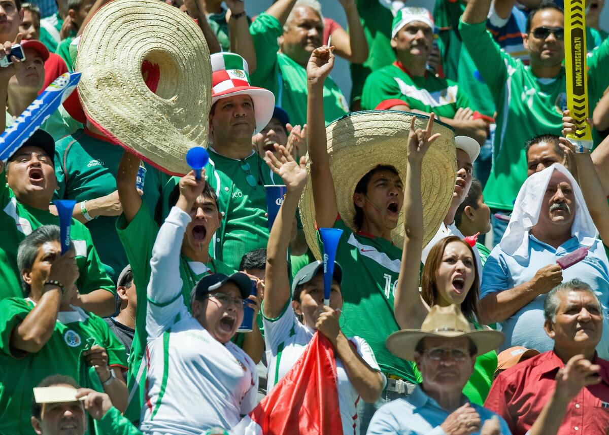Mexican fans celebrates a goal against the USA during their FIFA World Cup South Africa-2010 qualifier at Azteca stadium in Mexico City on August 12, 2009. AFP PHOTO/Ronaldo SCHEMIDT (Photo credit should read Ronaldo Schemidt/AFP/Getty Images) ** TCN OUT **