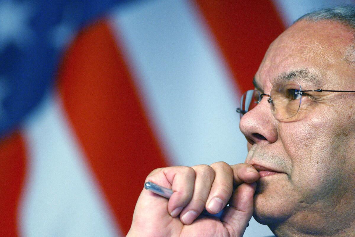 Colin Powell in 2006 with flag behind him