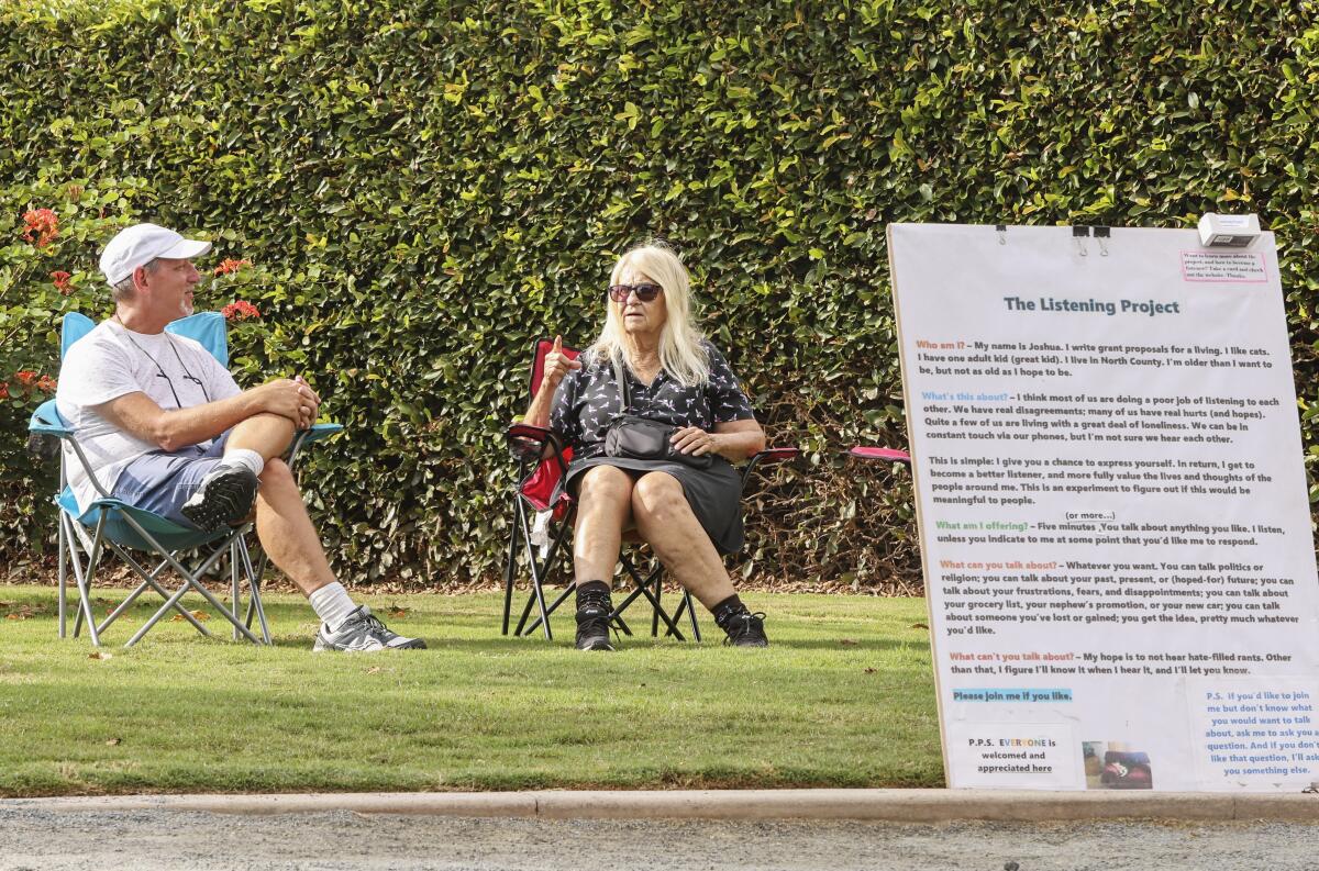 Joshua Lazerson, left, listens to Sara Ohara talk in Swami's Seaside Park.