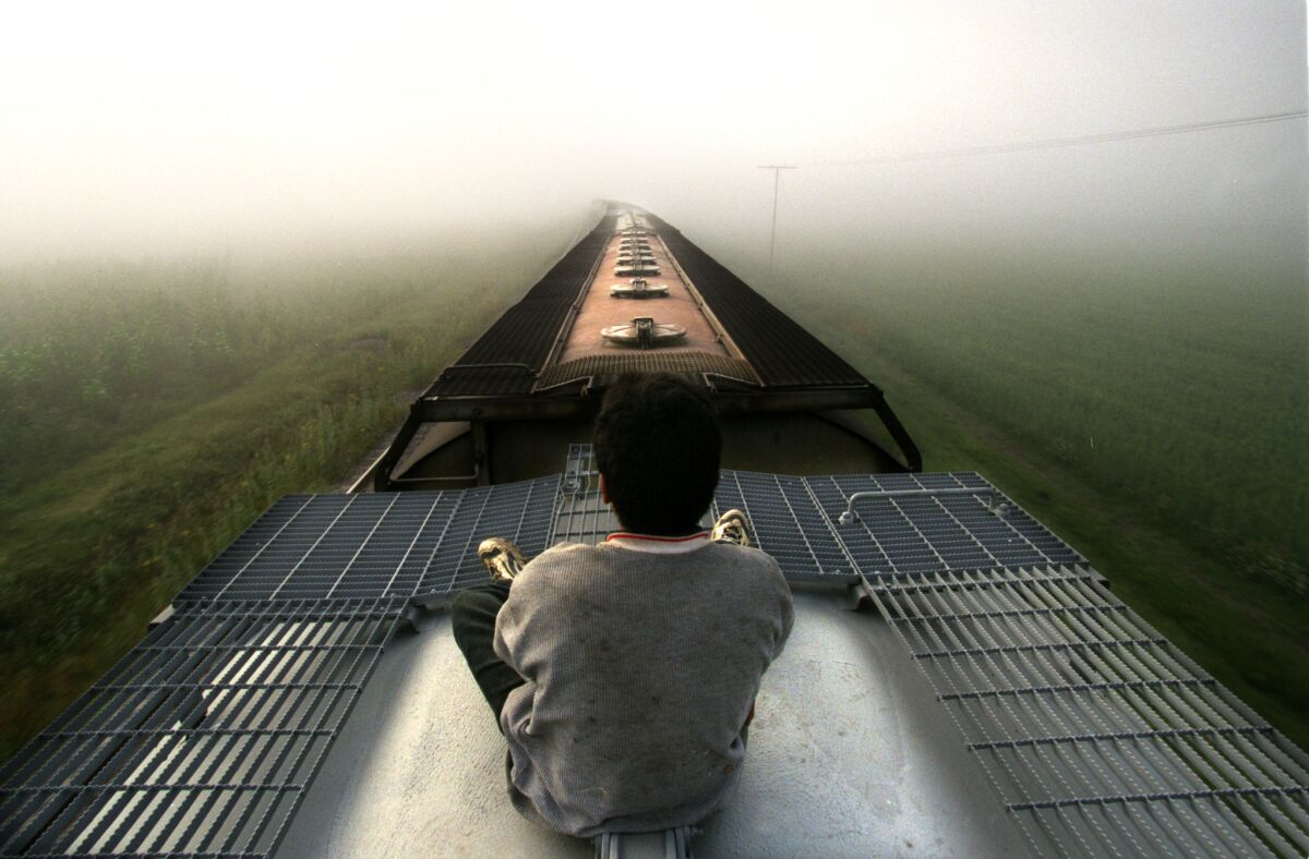 Boy rides atop a freight train through Mexico