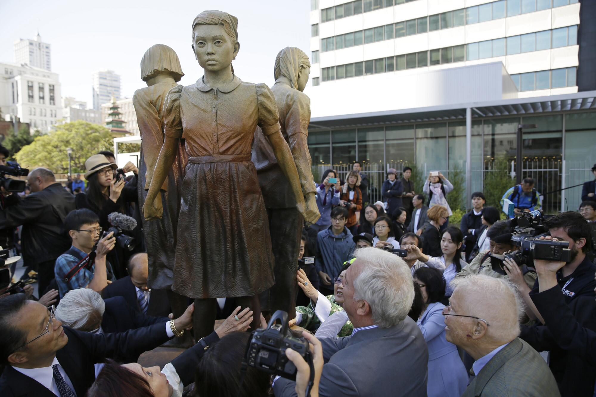 People surround the "Comfort Women" monument after its unveiling