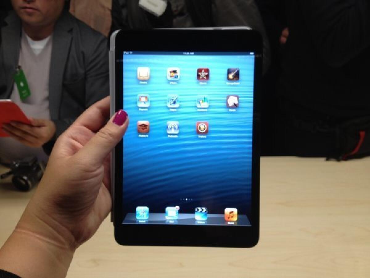Holding the iPad mini at Apple's invitation-only media event in San Jose on Tuesday.