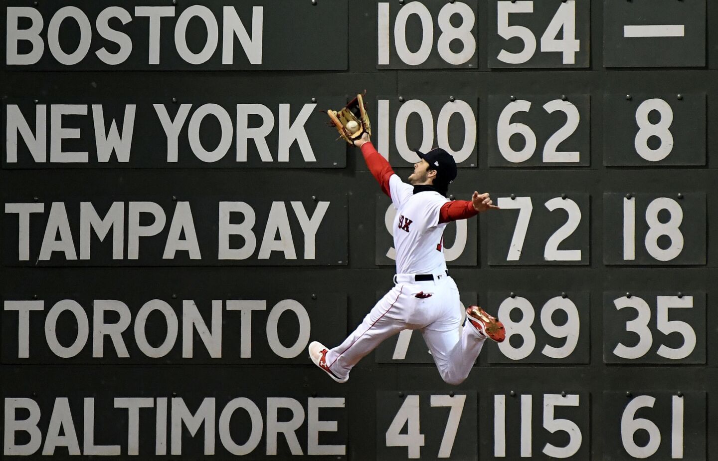 Red Sox Andrew Benintendi makes a leaping catch hit by Dodgers Brian Dozier in the 5th inning of Game 2 of the World Series at Fenway Park.