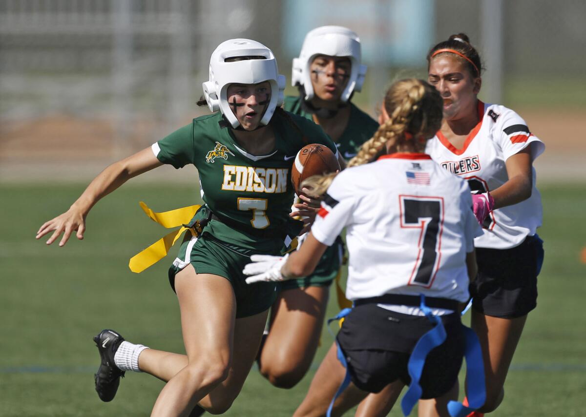 Edison receiver Emma Valenzuela looks for a gap in the defense as she runs upfield during a Sunset League flag football game.