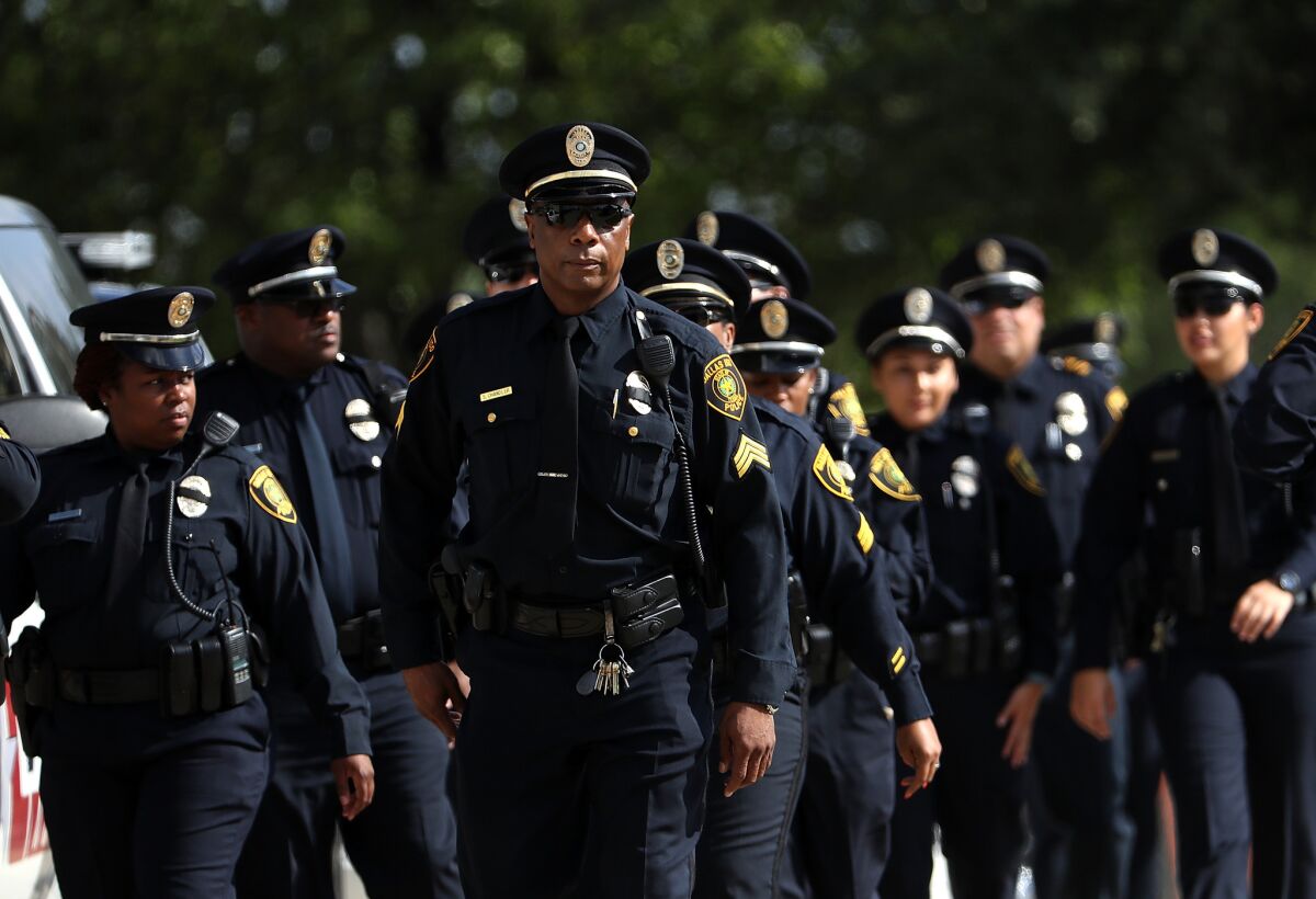 Police officers arrive at a funeral service for slain Dallas Area Rapid Transit (DART) police officer Brent Thompson on July 13, 2016 in Dallas, Texas.