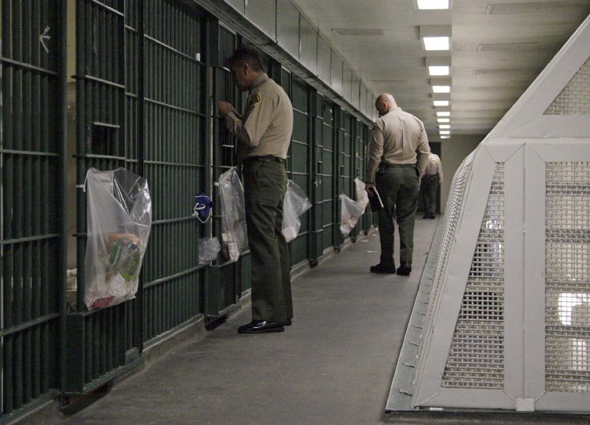 Some of the candidates running for L.A. County sheriff have embraced Lee Baca's education-based incarceration programs. Above, L.A. County Sheriff's deputies inspect a cell block in Men's Central Jail.