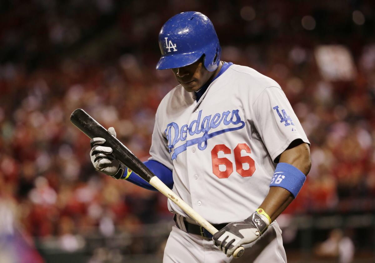 Yasiel Puig walks back to the Dodgers dugout after striking out in the eighth inning against St. Louis on Monday night.